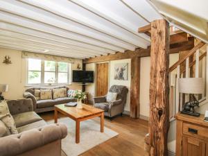 a living room with a couch and a table at The Wain House in Acton Scott