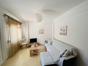 a living room with a couch and a table at Chrisa's Guest House in Skala Potamias
