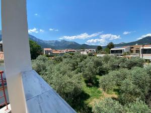 a view from the balcony of a house with trees and mountains at Chrisa's Guest House in Skala Potamias