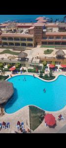 a large swimming pool in front of a hotel at شاليه فندقي ببورتو مارينا in El Alamein