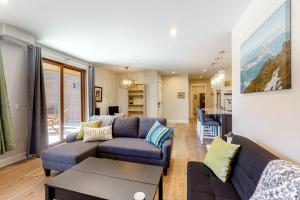 a living room with a couch and a table at Brand New Boardwalk Getaway in Grand Lake