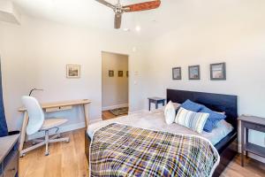 a bedroom with a bed and a desk and a chair at Brand New Boardwalk Getaway in Grand Lake