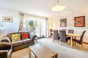 a living room with a couch and a table at 5 The Granary in Burneside