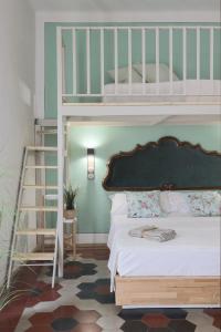 a bedroom with a bunk bed and a ladder at Donna Elena - Epoque Residence in Asti
