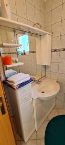 a small bathroom with a sink and a toilet at Urban Home Visoko in Visoko +26 photos