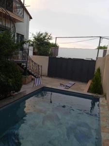 a swimming pool in the backyard of a house at Isolated second floor for rent with separate kitchen and bathroom in Tbilisi City