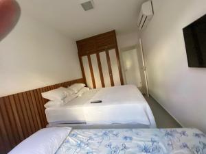 Säng eller sängar i ett rum på Apartamento Enseada Praia do Forte