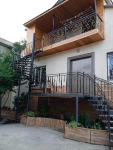 a house with a staircase on the side of it at Isolated second floor for rent with separate kitchen and bathroom in Tbilisi City