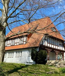 a large house with an orange roof at Großes Ferienhaus an der Ostsee "Oldevighus" in Hohenkirchen