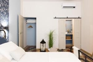 En eller flere senge i et værelse på Donna Elena - Epoque Residence