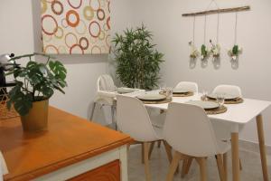 a dining room with a white table and white chairs at Casa do Chafariz in Vila Velha de Ródão