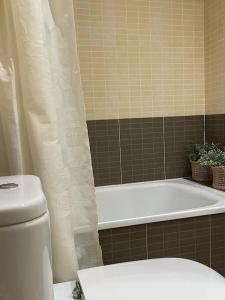 e bagno con vasca, servizi igienici e vasca. di Precioso apartamento con piscina en Moncofar a Moncófar