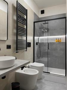 a bathroom with a toilet and a sink and a shower at Appartamento di design in Rome