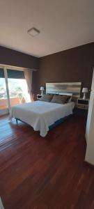 a bedroom with a large bed in a room at depto salta dean funes in Salta