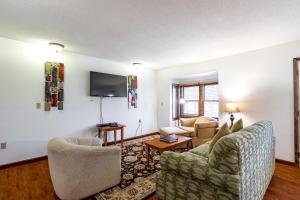 a living room with two chairs and a flat screen tv at Crown Resorts at Wolf Run in DuBois