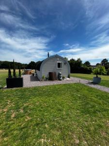 a white dome shaped building with a grass yard at The Cozy Cub in Romsey