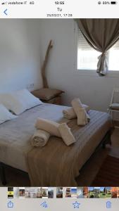 a bedroom with a bed with towels on it at Bilocale vista mare Es Pujols in Es Pujols