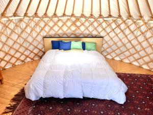 a bedroom with a white bed in a yurt at Alp Jurte Skihütte Feldis in Feldis