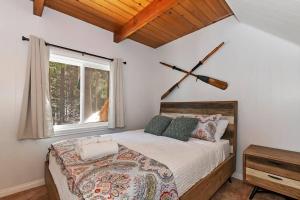 a bedroom with a large bed and a window at Lakes Edge Lodge A-frame steps away from the lake! in Lake Arrowhead