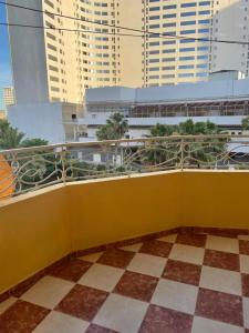 a yellow balcony with a view of a building at Complexe Jardins andalouse in Tangier