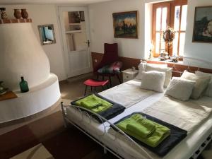 a bedroom with two beds and a living room at SzC Lovasbirtok in Lipótmajor