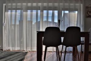 プリシュティナにあるMalda's Apartmentのダイニングルームテーブル(窓際の椅子2脚付) +14枚の写真