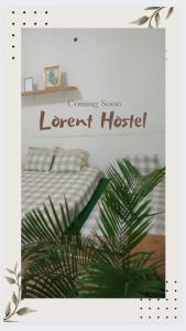 a sign for a room with a bed and a plant at LORENT HOSTEL in Kampungdurian