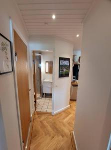 a hallway leading to a kitchen with a hallway leading to a room at Tórshavn City Apartment in Tórshavn