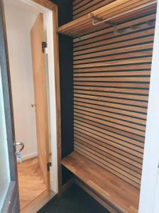 a room with a wooden door with wooden blinds at Tórshavn City Apartment in Tórshavn +31 photos
