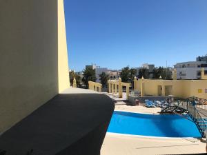 a view of a swimming pool from a building at Condo do Mar Lovely first floor apartment with pool in Lagos