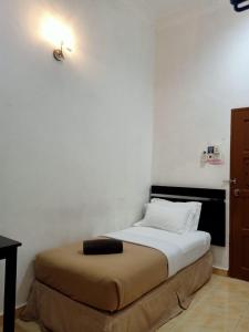 Postel nebo postele na pokoji v ubytování ANGGERIK IMPIAN HOTEL -Best for Travellers at Kuala Berang