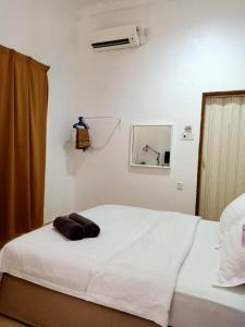 Postel nebo postele na pokoji v ubytování ANGGERIK IMPIAN HOTEL -Best for Travellers at Kuala Berang