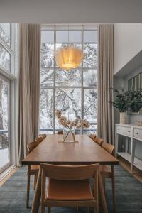 a dining room with a table and a large window at Stepping Stone in Thredbo