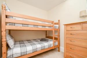 a bedroom with two bunk beds and a dresser at Street House Farm Cottage in Saltburn-by-the-Sea