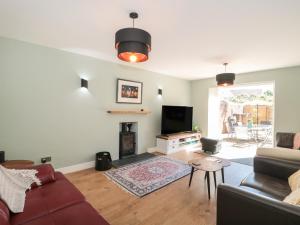 a living room with a couch and a tv at 1 Charlotte Close in Bournemouth