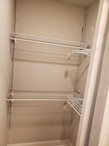 a walk in closet with metal shelves and a mirror at Bright & Spacious Studio Close to CLT Airport in Gastonia