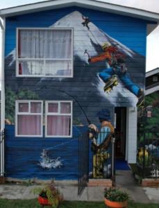 a house with a painting on the side of it at Hostal Brisas del Sur in Puerto Varas
