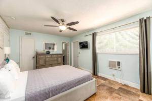 a bedroom with a bed and a ceiling fan at Steps to Sand and Sea 4 in Fort Lauderdale