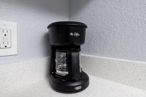 a coffee maker sitting on a counter next to a wall at Shell on the Beach 107 - RENOVATED in Hollywood