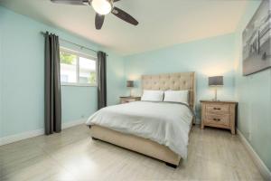 a bedroom with a bed and a ceiling fan at Steps to Sand and Sea 2 in Fort Lauderdale