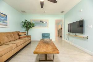 a living room with a couch and a coffee table at Steps to Sand and Sea 3 in Fort Lauderdale
