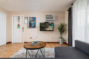 a living room with a couch and a table at Shell on the Beach 101 in Hollywood