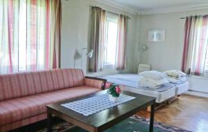 a living room with a couch and a coffee table at Holiday Home Möllstorpsgatan Färjestaden in Färjestaden