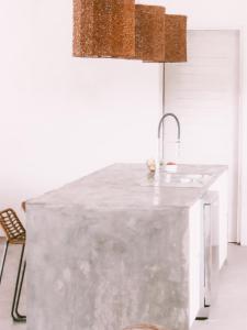 a kitchen with a concrete counter with a sink at The Moso in Port Vila
