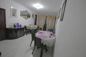 a living room with tables and chairs in a room at Hospedaje Solianka in Bogotá