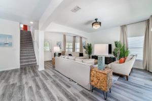 a living room with a couch and chairs at Romantic forest view 5BR Minutes to Disney in Kissimmee