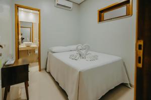 Un pat sau paturi într-o cameră la Pousada Vila Verde