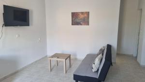 a living room with a couch and a table at Seaside appartment to enjoy,relax with great view in Gázion