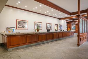 a large lobby with a reception counter in a building at Aston at the Waikiki Banyan in Honolulu