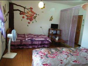 En eller flere senger på et rom på Lanyu My Home B&B